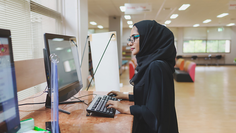 Women studying and engaging at western universities' campuses in Qatar and the UAE, highlighting education opportunities.